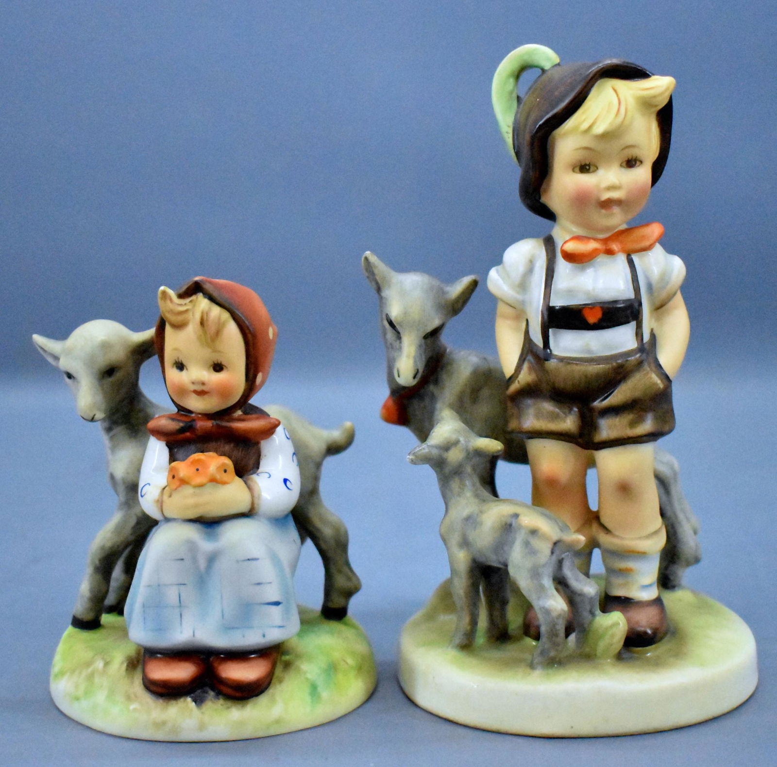 Goebel Hummel 182 and 200/1 figurines: Goebel Hummel 182 Good Friends with partial label, 1960-72 mark and 200/1 Little Goat Herder with stamped full bee from 1950-55, both in excellent to near mint condition but no boxes.