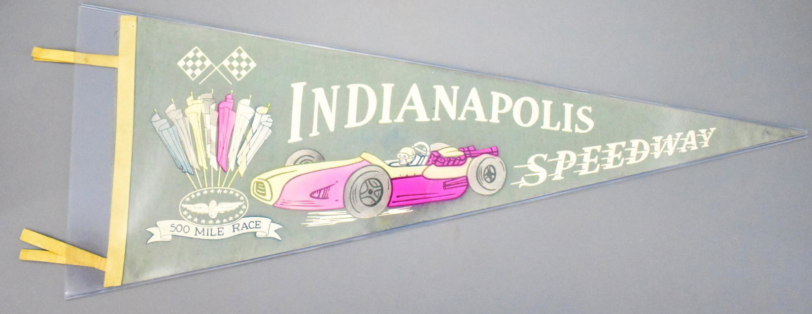 Vintage 1950's Indy 500 Indianapolis Motor Speedway: Vintage 1950's Indy 500 Indianapolis Motor Speedway felt pennant, it is faded with a small tear to the skinny end that has a piece of tape on it, still has good color and displays nicely, measures 30"