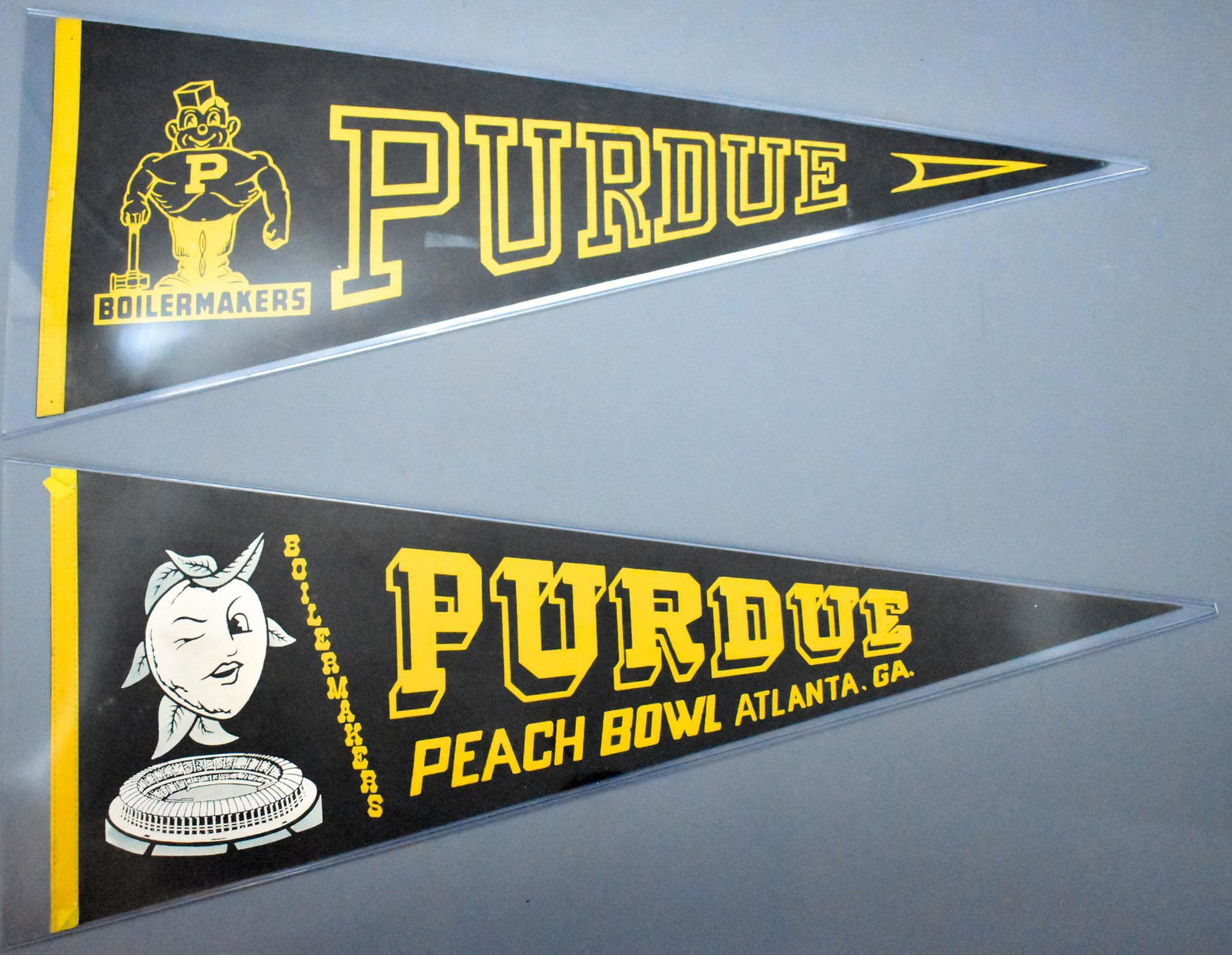 Two vintage Purdue University felt pennants including: Two vintage Purdue University felt pennants including 1978 Peach Bowl, both in excellent condition and measuring 29 1/2" long.