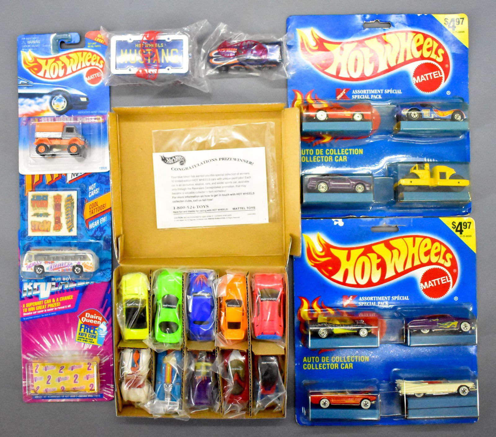 Mixed group of Hot Wheels with two rare Canadian 4-car: Mixed group of Hot Wheels with two rare Canadian 4-car assortiment packs that were sold at K-Mart, an Avon Park-n-Plates Mustang, boxed set of revealers and more as seen in the photos.