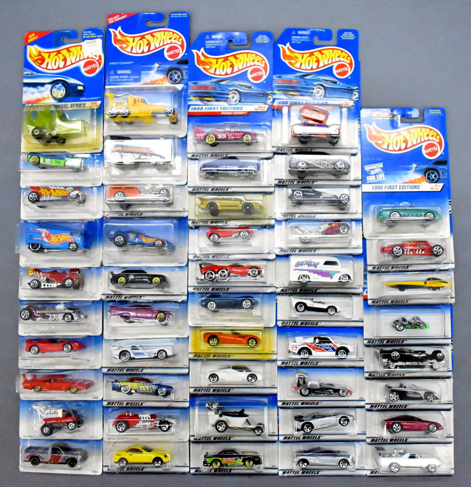 Forty-eight Hot Wheels racing and hot rod die cast cars: Forty-eight Hot Wheels racing and hot rod die cast cars, mint on sealed blister cards as seen in the photos.