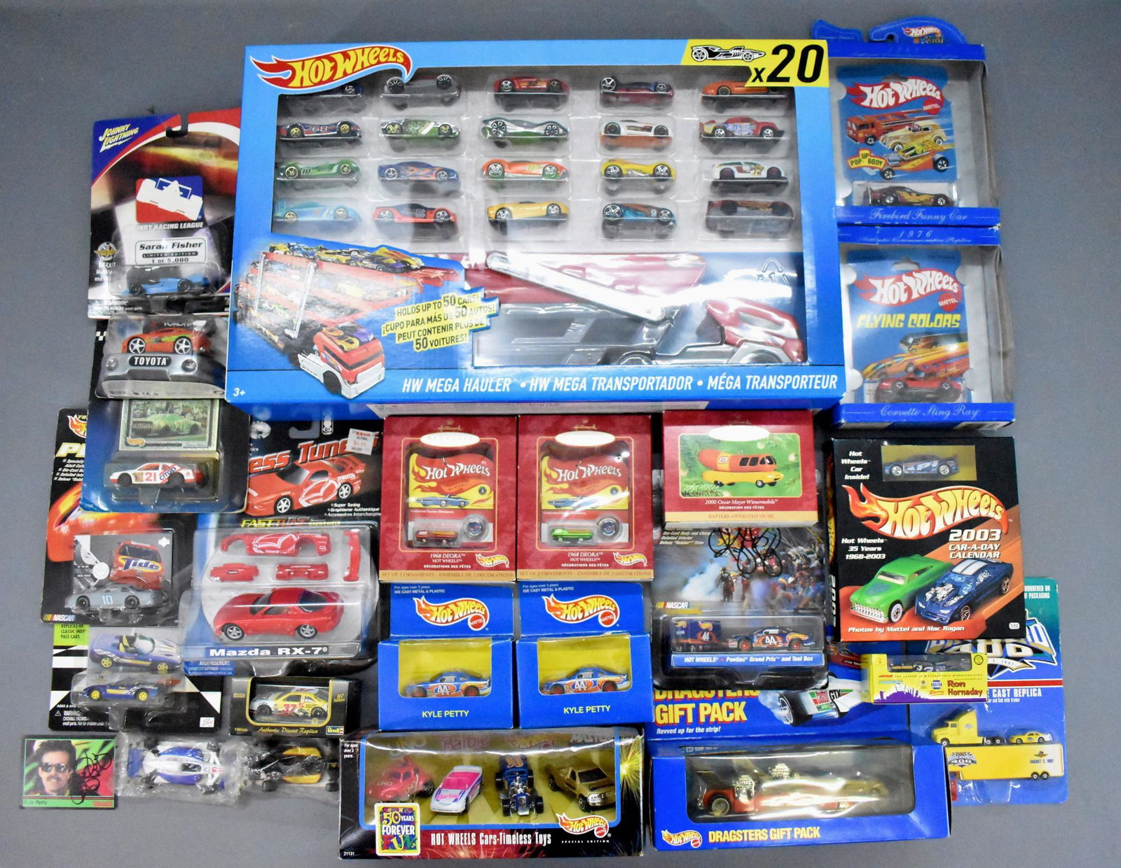 Mixed group of Hot Wheels and other die cast cars MOC: Mixed group of Hot Wheels and other die cast cars, mint on sealed blister cards and a Mega Hauler with 20 cars mint in a factory sealed original box as seen in the photos.