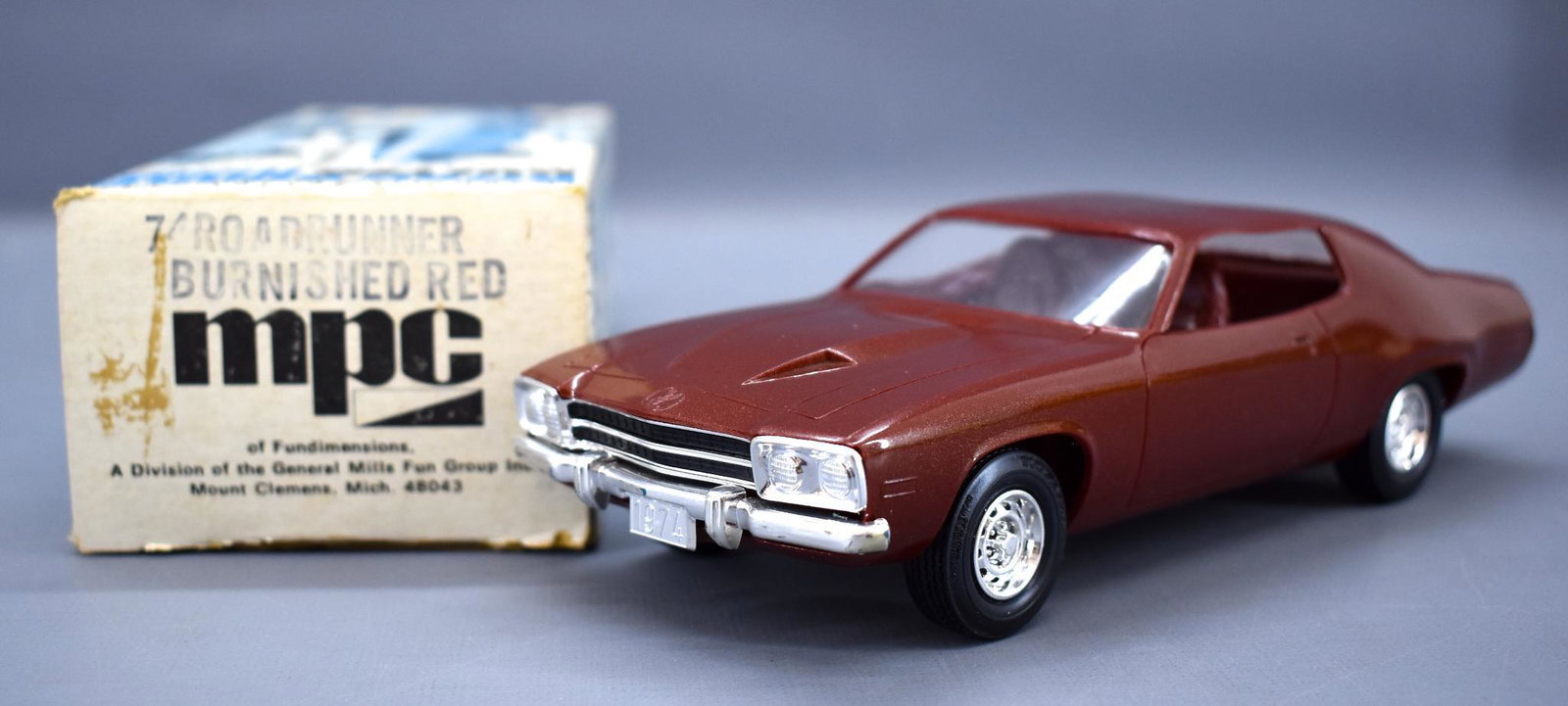 MPC 1974 Plymouth Road Runner dealer promo car in: MPC 1974 Plymouth Road Runner in Burnished Red dealer promo car in original box. Car is in near mint condition, box is overall very nice with some light shelf wear.