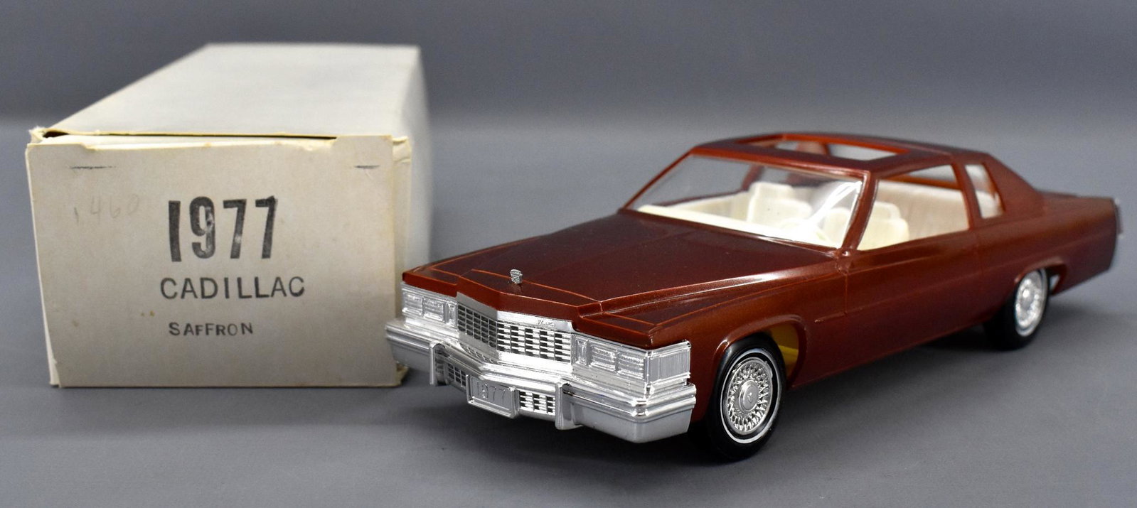 Johan 1977 Cadillac Coupe de Ville dealer promo car in: Johan 1977 Cadillac Coupe de Ville in Saffron dealer promo car in original box. Car is near mint with a good box with light shelf wear.