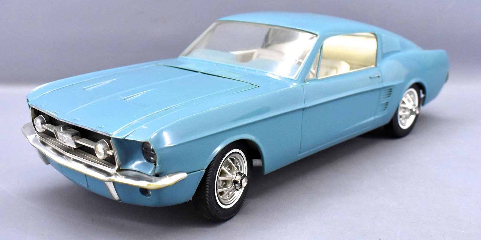 Wen-Mac 1967 Ford Mustang GT fastback motorized large: Wen-Mac 1967 Ford Mustang GT fastback motorized large scale promo car. Car is missing one of the rear tabs that hold the body in place and the battery box shows corrosion, it has not been tested. The 