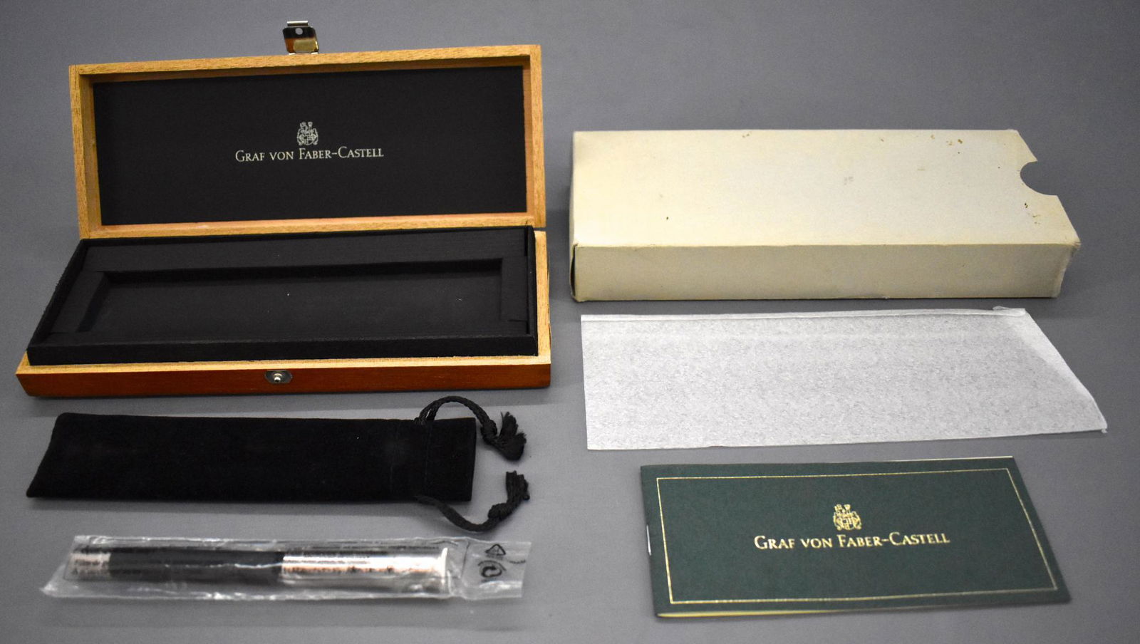 Graf von Faber-Castell Ebony fountain pen in original: Graf von Faber-Castell Ebony fountain pen in original box. Pen has been used but is in excellent condition with an 18 karat gold nib. The wooden case is near mint with labels and has a cardboard sleev