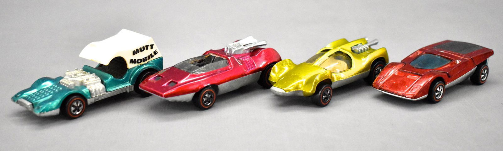 Four Redline Hot Wheels concept cars: Four Redline Hot Wheels concept cars in better than "filler grade" but all have wear or toning to include red HK Ferrari 512S, rose US Peeping Bomb, aqua HK Mutt Mobile with dog and a yellow US Mantis