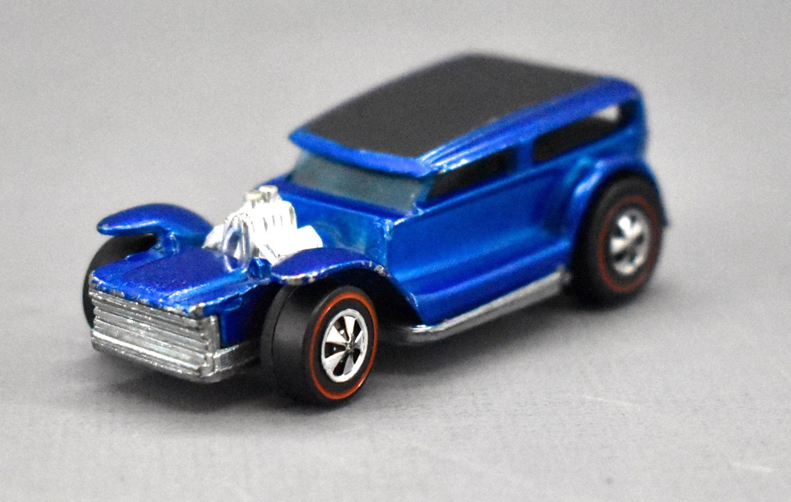 Redline Hot Wheels blue HK The Demon: Redline Hot Wheels blue HK The Demon, a very clean car that does have paint / play wear as seen in the photos and a shiny base.