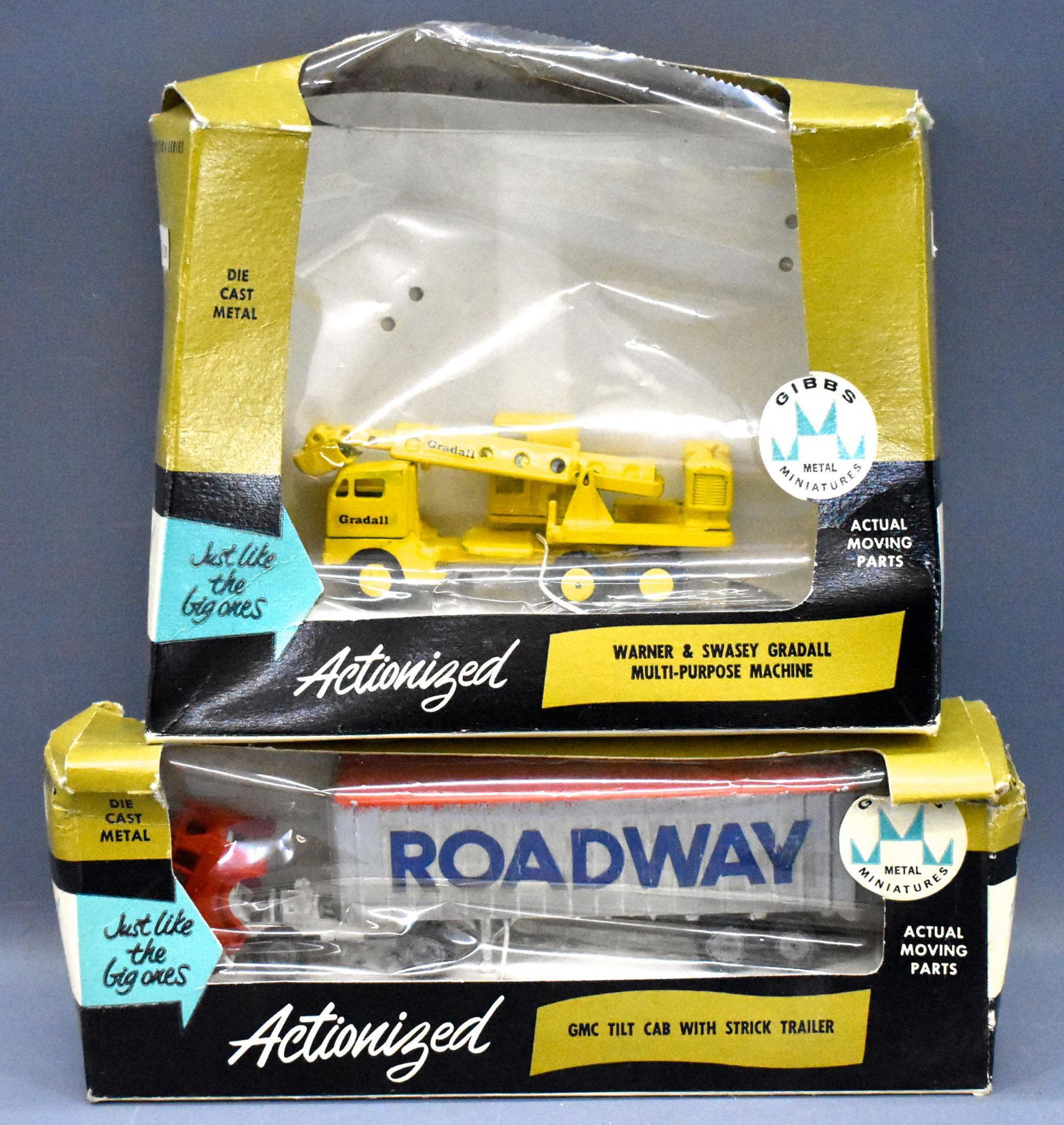 Two Gibbs Metal Miniatures die cast toys in original: Two Gibbs Metal Miniatures die cast toys in original boxes to include Roadway GMC tilt cab with strick trailer and a Warner & Swasey Gradall multi-purpose machine. Both toys are near mint in fair to g