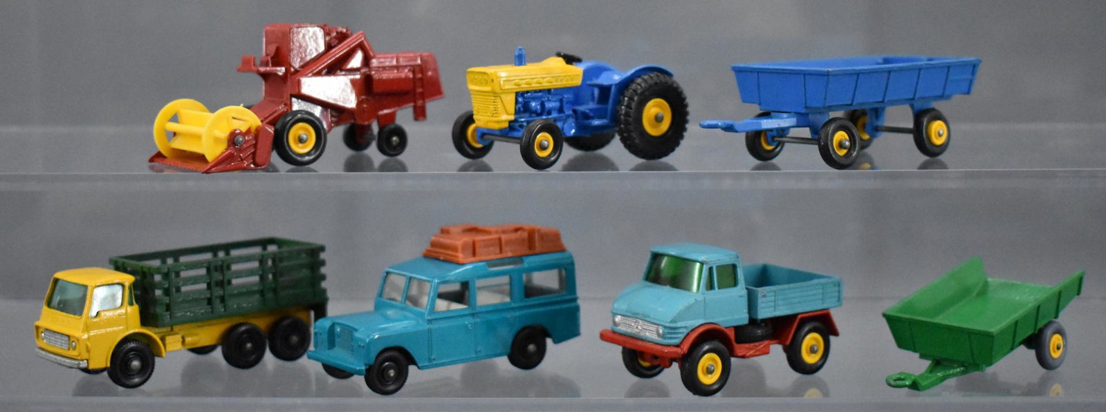 Group of vintage Matchbox regular wheels die cast toys: Group of vintage Matchbox regular wheels die cast toys to include a combine, tractor, three trucks and two trailers in very good to excellent condition with some loose wheels as seen in the photos.