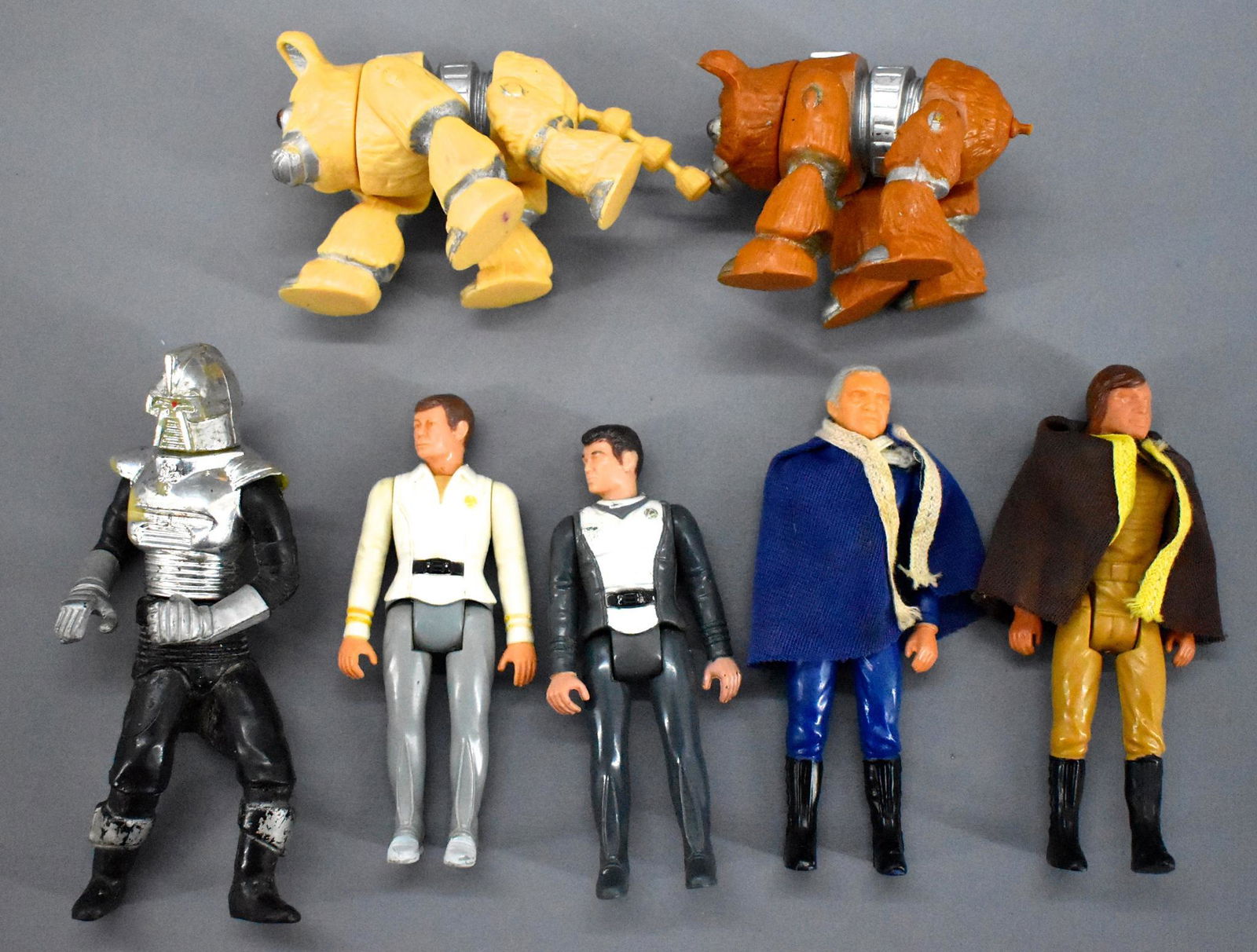 Group of Mattel Battlestar Galactica action figures and: Group of Mattel Battlestar Galactica action figures to include Starbuck, tan and brown Daggett figures (one with a mostly missing tail), Commander Adama and a Cylon Centurian plus Mego Star Trek Bones