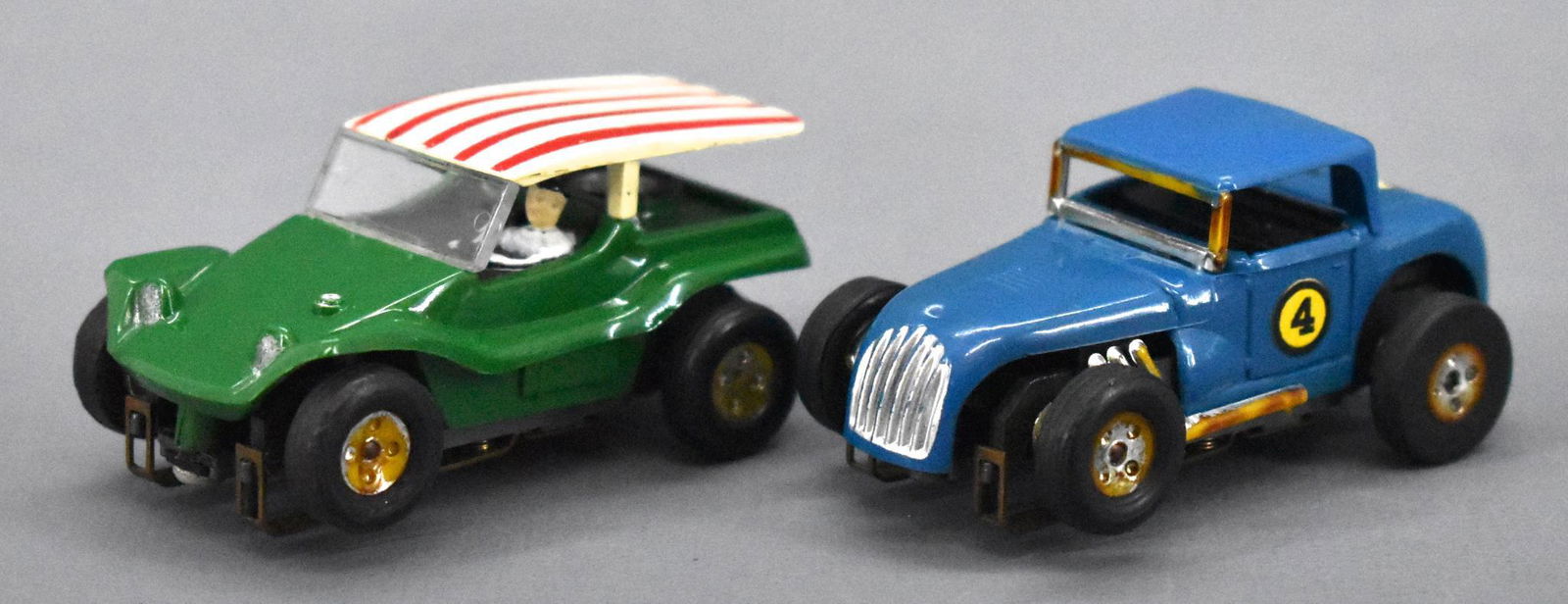 Two nice vintage Aurora T-Jet HO slot cars: Two nice vintage Aurora T-Jet HO slot cars to include a green dune buggy coupe and a blue hot rod coupe with some decals. Both are in excellent condition as seen in the photos.