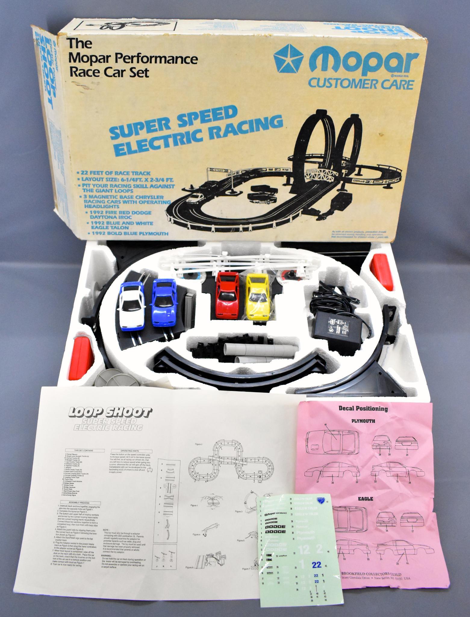 Mopar Customer Care Electrim Power LOOP SHOOT HO racing: Mopar Customer Care Electrim Power LOOP SHOOT HO racing set in original box. Set has been used but is in excellent condition with all track, controllers and four cars with unused sticker sheet and an 