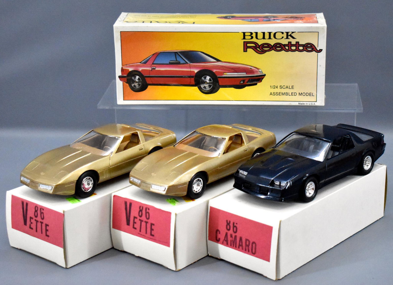 Group of four 1980's dealer promo cars in original: Group of four 1980's dealer promo cars in original boxes to include 1986 camaro, two 1986 Corvettes and a factory sealed 1988 Buick Reatta. All four cars are near mint to mint in excellent original bo