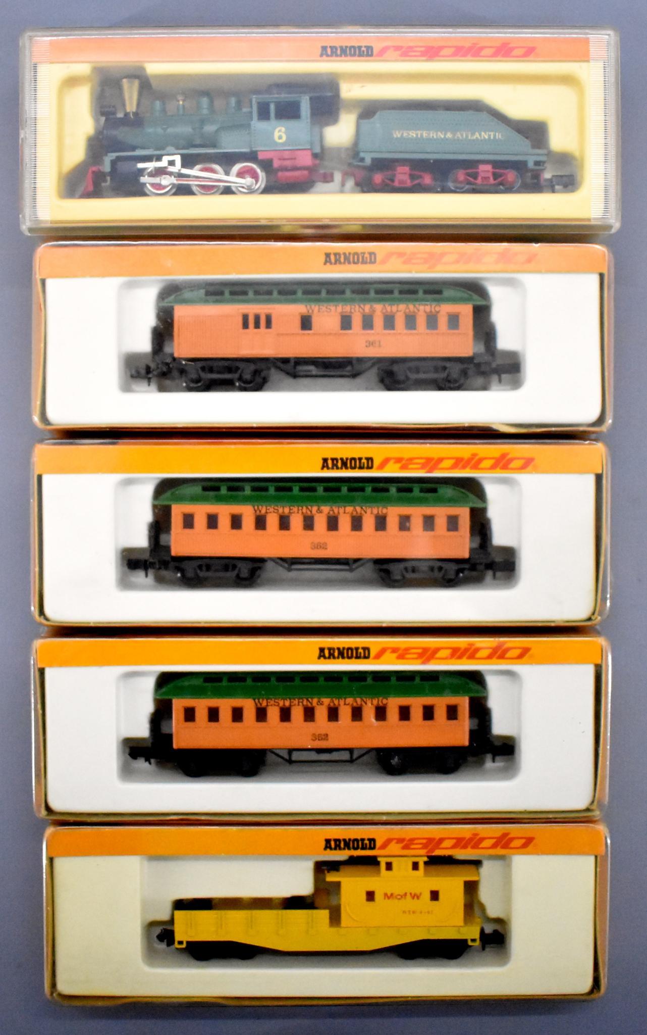 Five Rapido N gauge trains in original boxes Old time: Five Rapido N gauge trains in original boxes to include an old time steam passenger set with an 0226 steam locomotive, 0361 combine and two 0362 coaches plus an 0472 M of W work caboose, all C7+ in ve