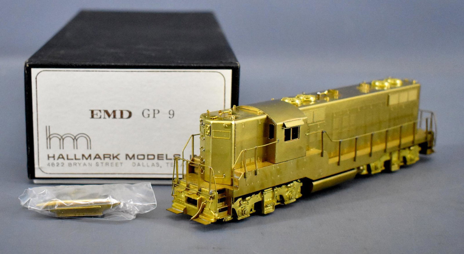 Hallmark HO brass EMD GP-9 diesel locomotive in: Hallmark HO brass EMD GP-9 diesel locomotive in original box, unrun and likely recently unwrapped for the first time. It does have some factory tarnish on one side as seen in the photos. Includes a ne