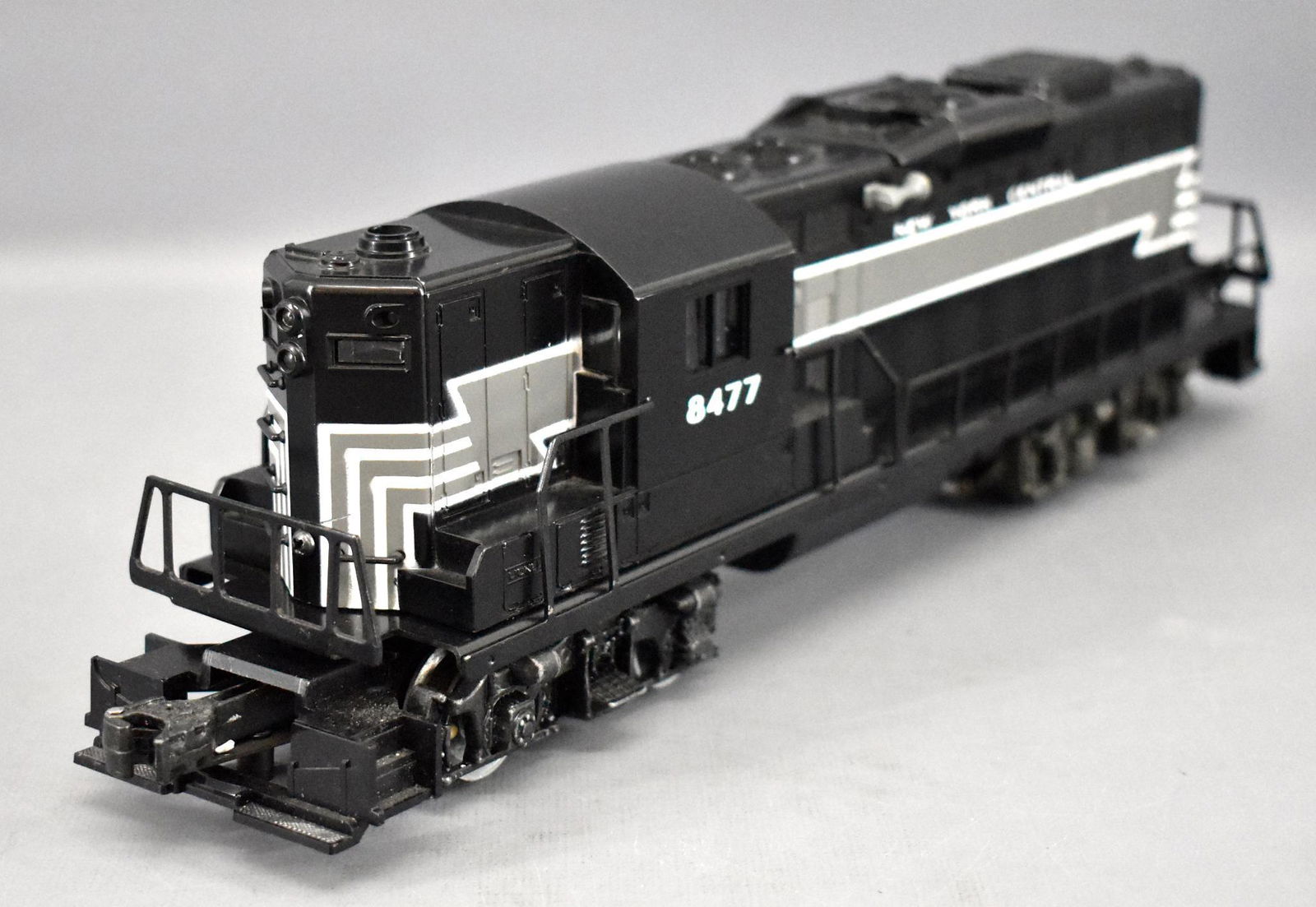 Lionel modern era O gauge New York Central GP-9 diesel: Lionel modern era O gauge New York Central GP-9 diesel locomotive #8477, C5-6 with scratches on the side of the cab and issues with the front truck assembly. Comes in an incorrect box that is good for