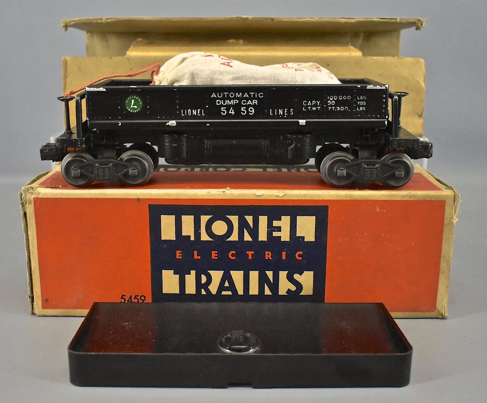 Lionel postwar O 5459 electronic set automatic dump car: Lionel postwar O 5459 electronic set automatic dump car in original box, C6 with one reproduction decal, good original box, liner, 160 bin and 207 bag of coal.