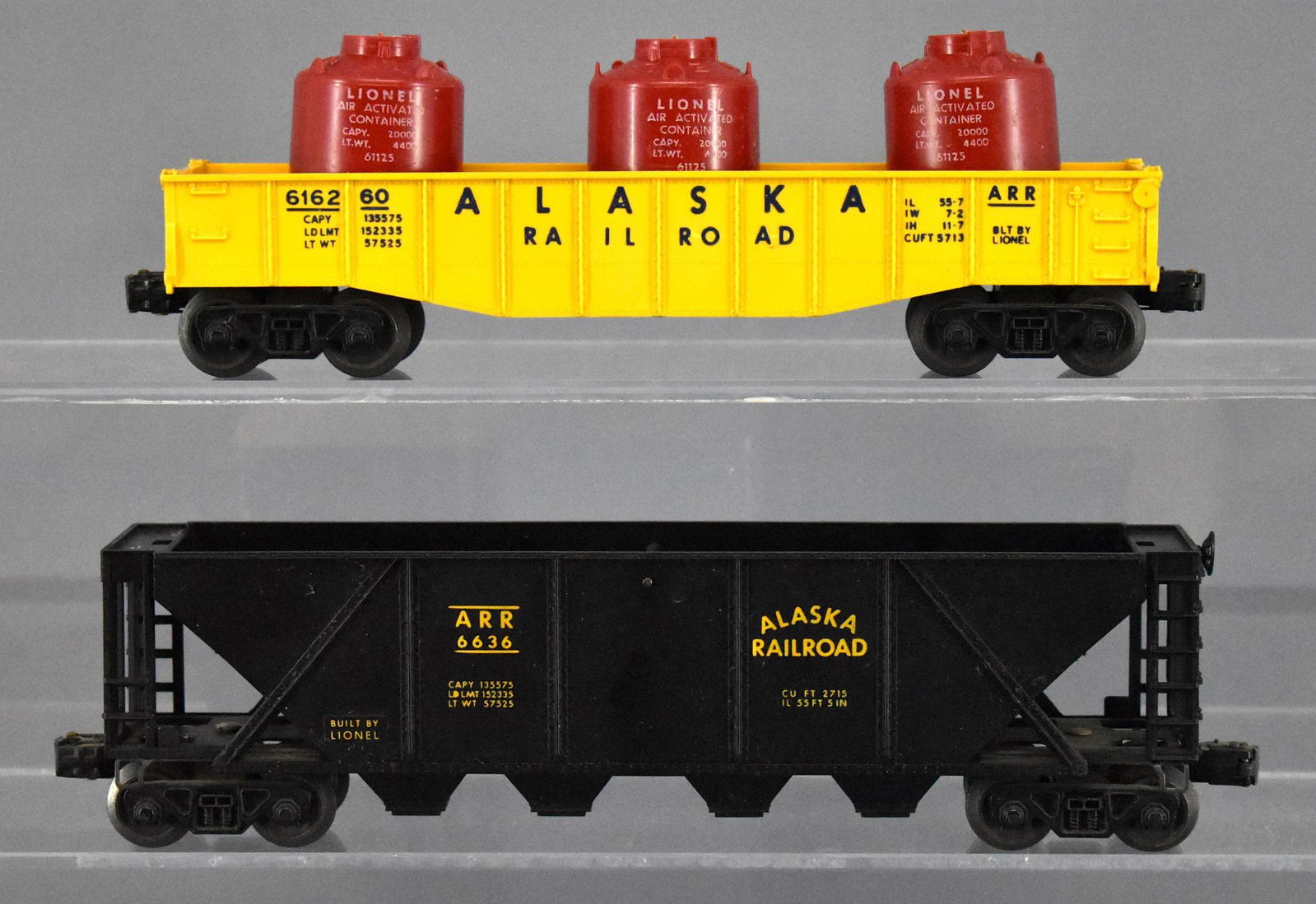 Group of 2 Lionel postwar O gauge Alaska railroad cars: Group of 2 Lionel postwar O gauge Alaska railroad cars. Group includes 6162-60 Gondola with canisters and a 6636 Quad hopper, C7.