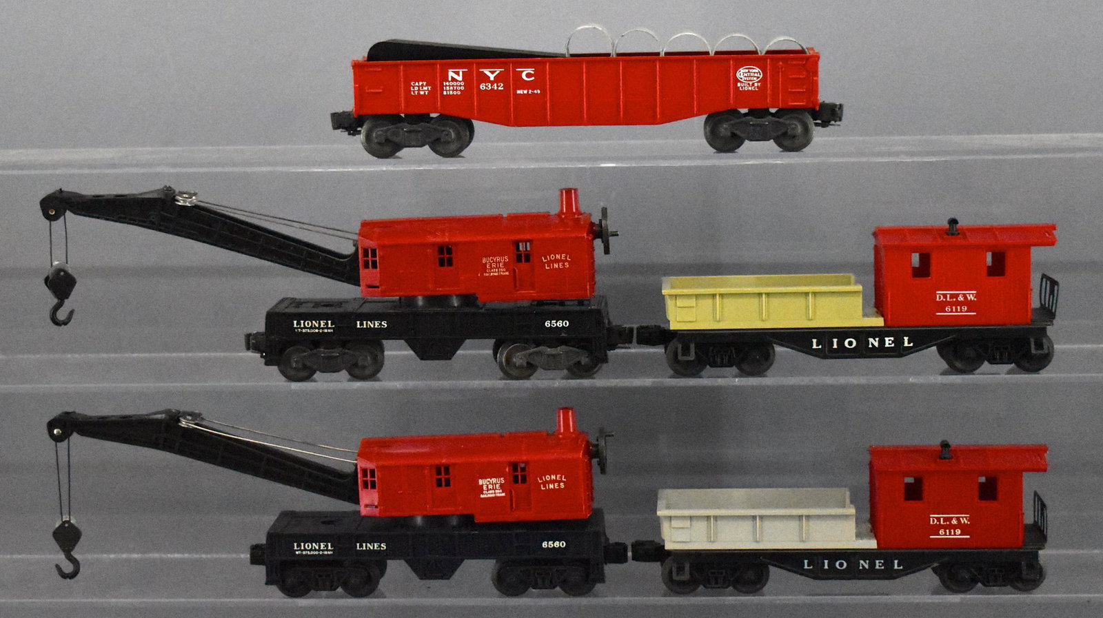 Group of five Lionel postwar O gauge train cars: Group of five Lionel postwar O gauge train cars, group includes two 6119 work caboose cars, two 6560 operating crane cars and a 6342 red gondola car with culvert pipes, C6-7.