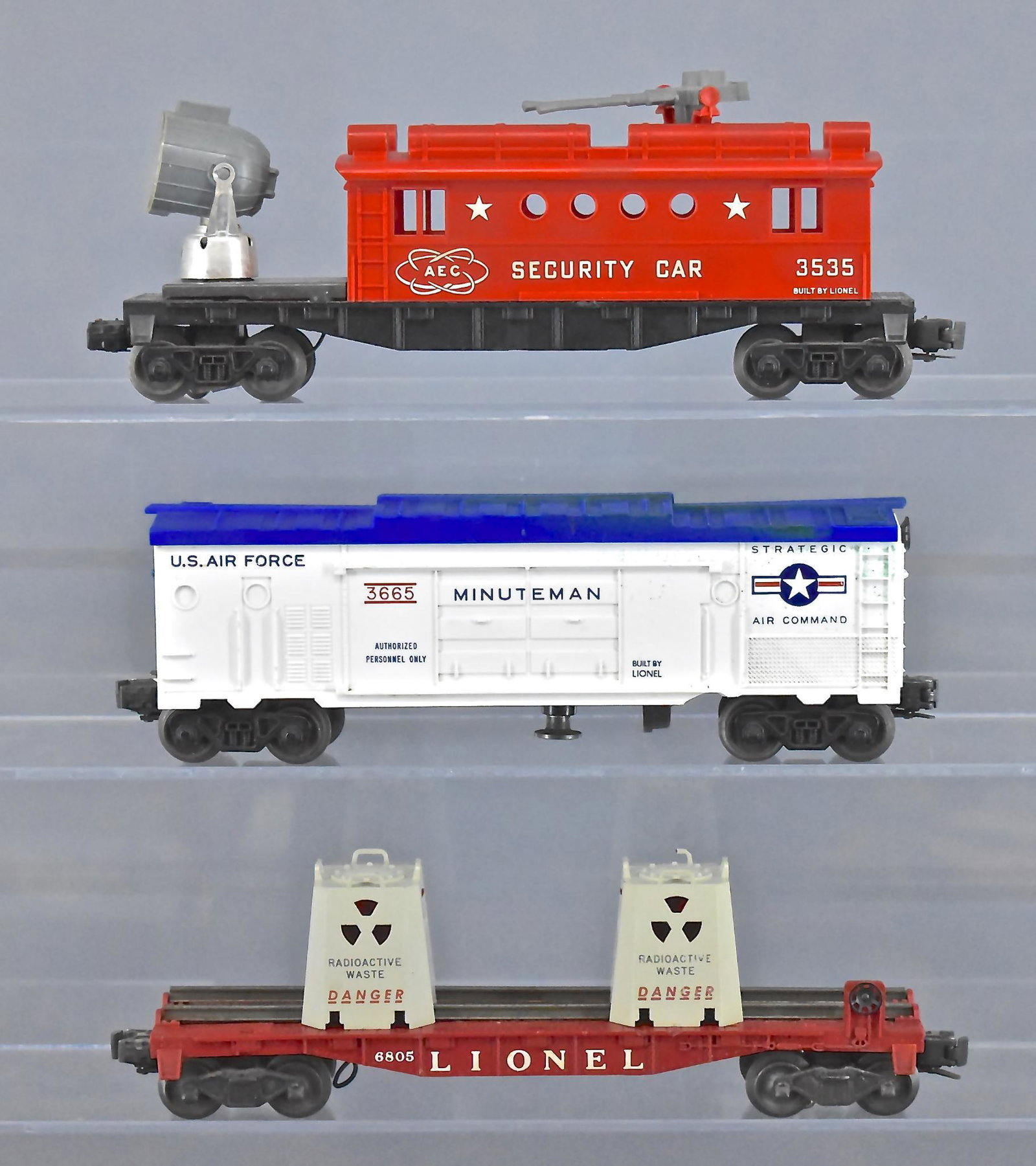 Group of three Lionel postwar O gauge military space: Group of three Lionel postwar O gauge military space cars . Group includes 3535 security car, 6805 radioactive waste car and 3665 missile launch box car, C5-6.