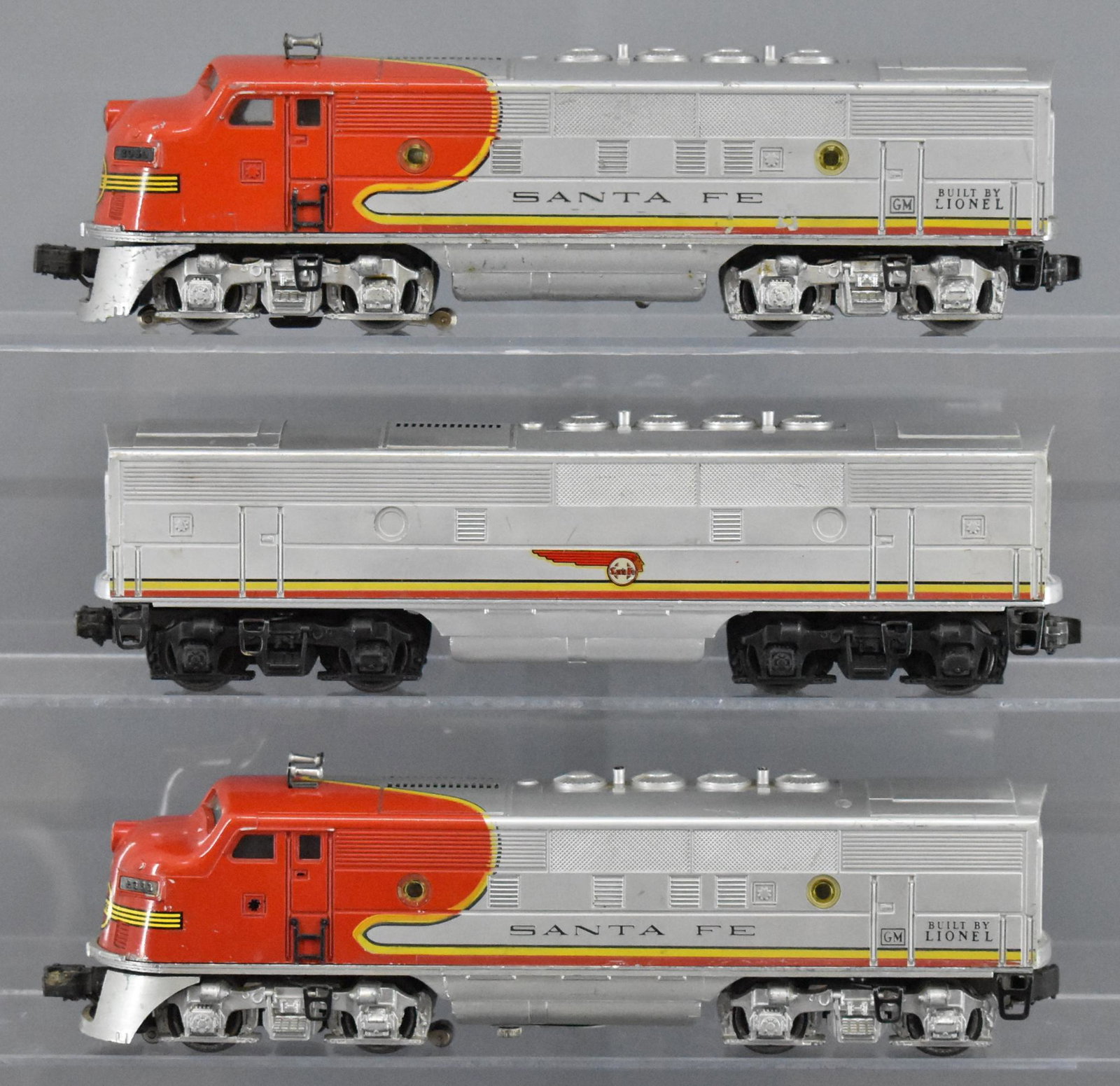Lionel postwar O 2353 Santa Fe F3 AA set with 2243 B: Lionel postwar O 2353 Santa Fe AA set with 2243 B unit, All three show moderate to heavy run time and are C5, no battery damage.