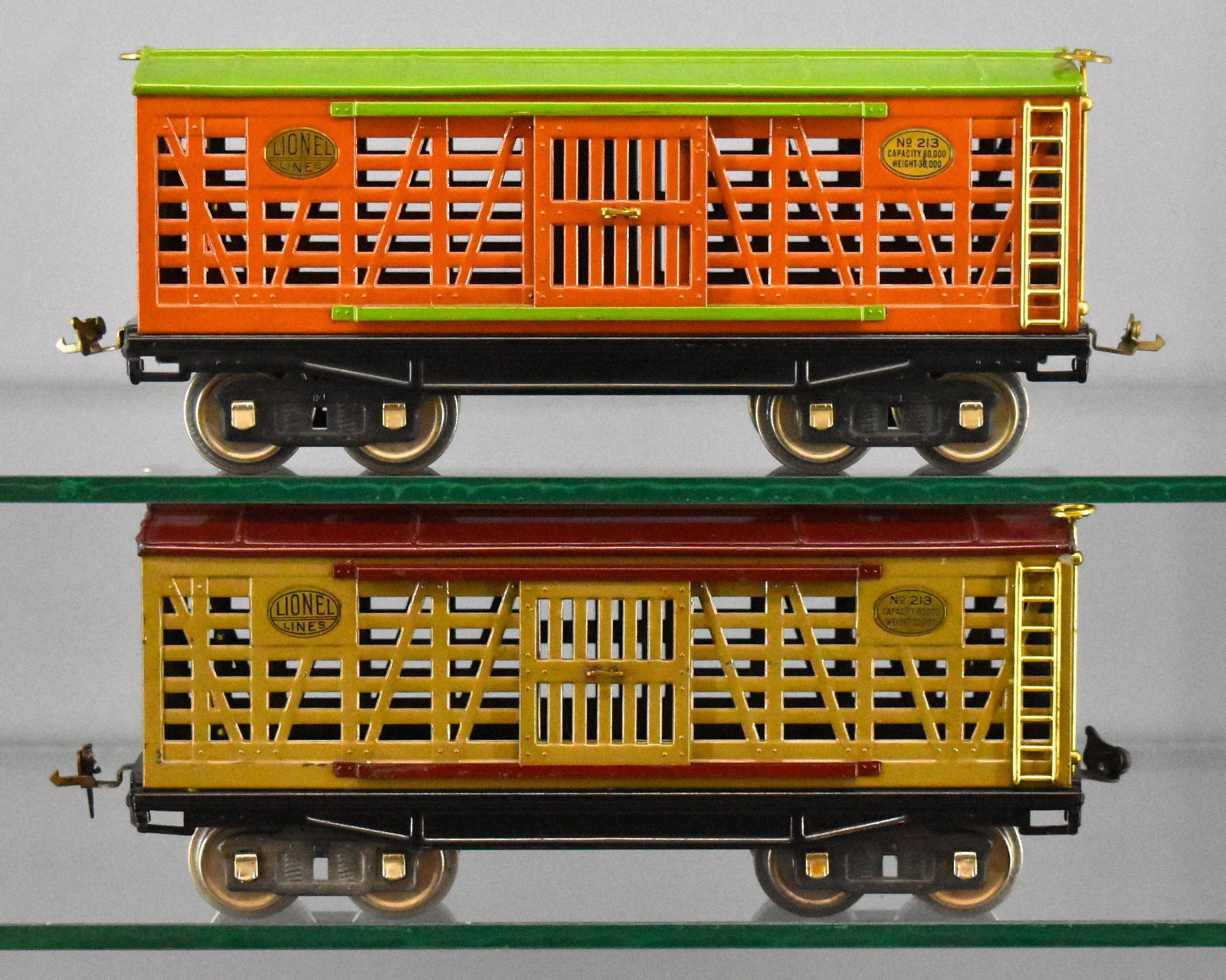 Two Lionel prewar standard gauge 213 stock cars: Two Lionel prewar standard gauge 213 stock cars, one orange with a green roof, the other is Mojave with a Maroon roof, C7.