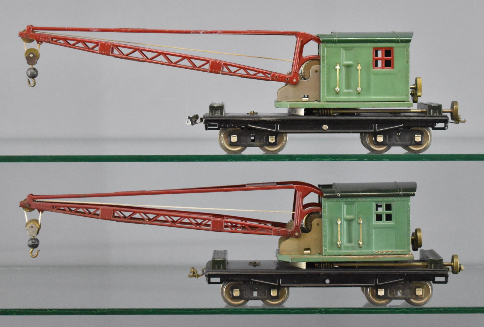 Two different Lionel prewar standard gauge 219 crane: Two different Lionel prewar standard gauge 219 crane cars, both peacock blue cabs but one has red window insert and a bright green roof while the other has a dark green roof and peacock blue window in