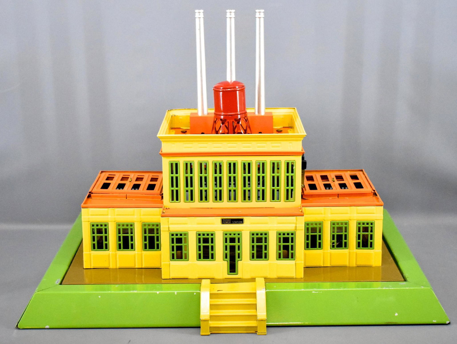T-Reproductions Lionel 840 industrial power station: T-Reproductions Lionel 840 industrial power station in green, yellow and orange, C6 with some paint loss on the base and a dinged corner of the top of the building, otherwise complete.
