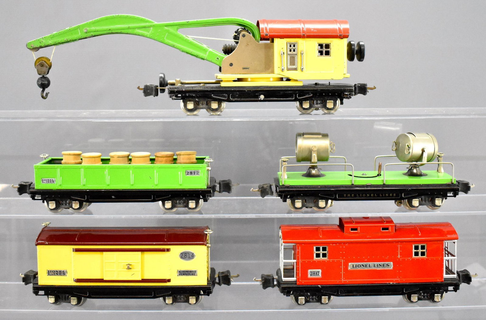 Five Lionel prewar O gauge 2800 freight cars with all: Five Lionel prewar O gauge 2800 freight cars with all nickel trim to include 2812 gondola with barrels, 2814 box car, 2810 crane car, 2820 searchlight car and 2817 caboose, C6-7.