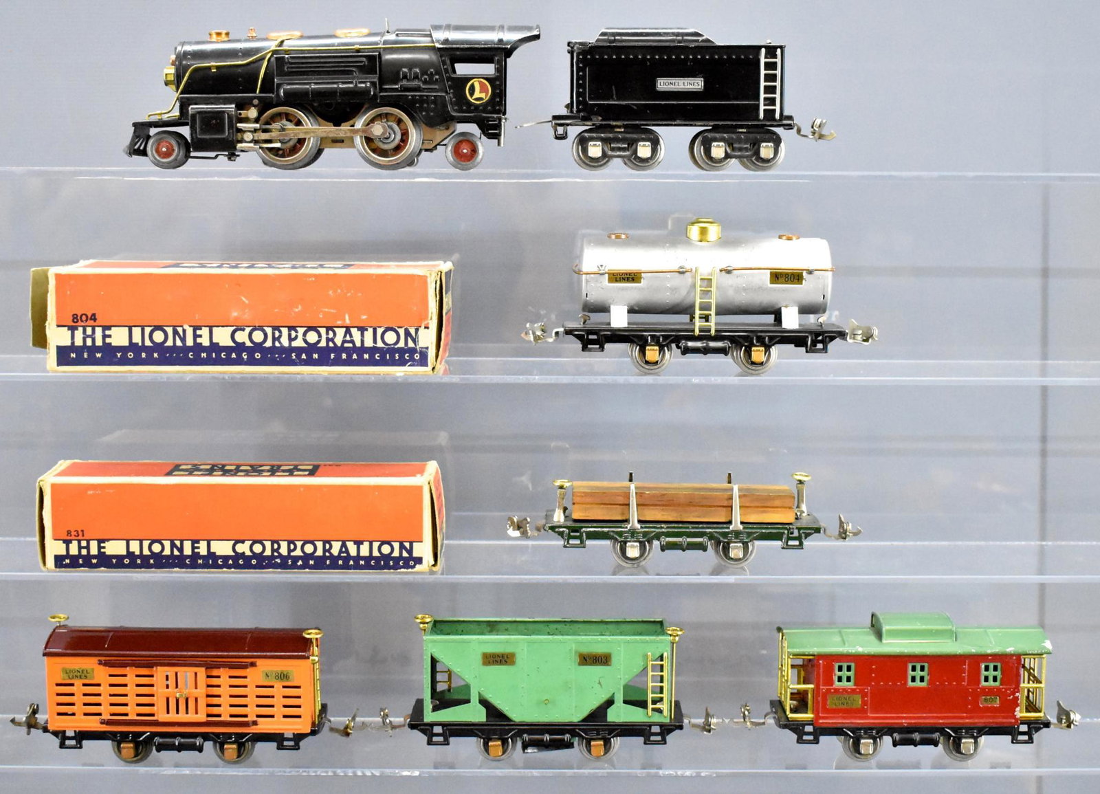 Lionel prewar O gauge steam freight set with 259E steam: Lionel prewar O gauge steam freight set with 259E steam locomotive, sheet metal tender, 803 hopper, 804 tank car, 806 restored stock car, 807 caboose and 831 lumber car, C5-6. Includes worn 804 and 83
