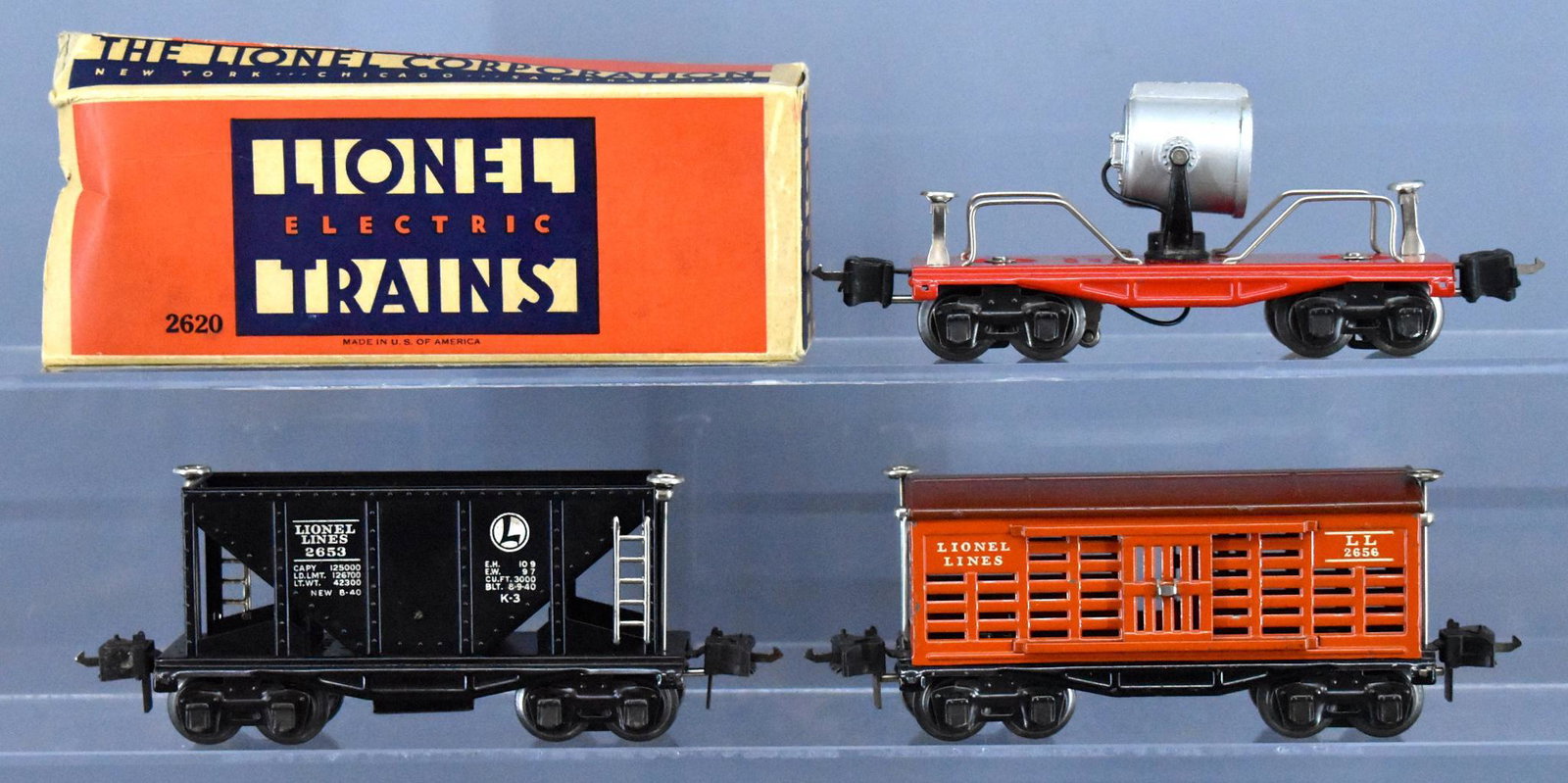 Lionel prewar O gauge 2653 2656 2620 tinplate cars with: Lionel prewar O gauge 2653 hopper, 2656 stock car and 2620 searchlight car with one original box, C7-8 trains with a worn 2620 box.