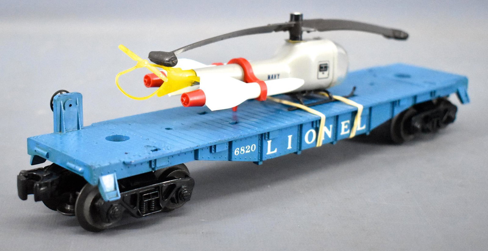 Scarce Lionel postwar O 6820 aerial missile transport: Scarce Lionel postwar O 6820 aerial missile transport car w/ original copter, car shows very light run time but does have some rubs on the top of the flat car, C7. the helicopter is all original with 