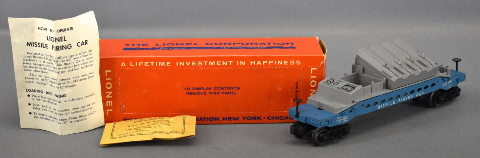 Lionel postwar O 6544 missile firing trail car in: Lionel postwar O 6544 missile firing trail car in original box with black console in original box. Car shows very light run time but has hairline cracks on both ends around the brake stands. They are 