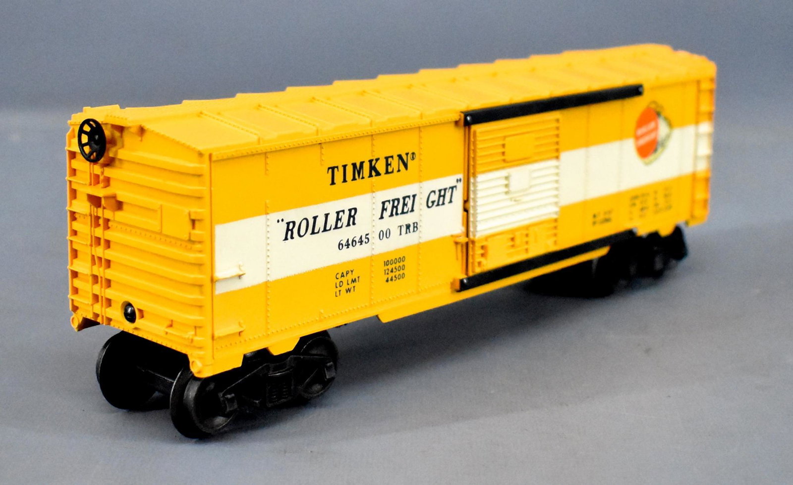 Lionel postwar O 6464-500 buttercup yellow Timken box: Lionel postwar O 6464-500 Timken box car, type IIb buttercup yellow body mold with a painted white stripe, C8.