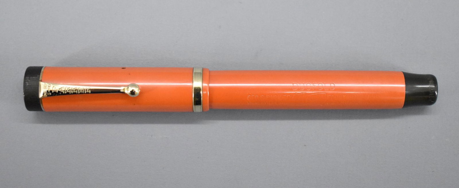 Parker Duofold fountain pen, Big Red Parker Duofold: Parker Duofold fountain pen, Big Red Parker Duofold. 14k Gold nib. Measures 5 1/2 inches in length with the cap screwed on. This pen has been used at some point and may or may not be missing inte