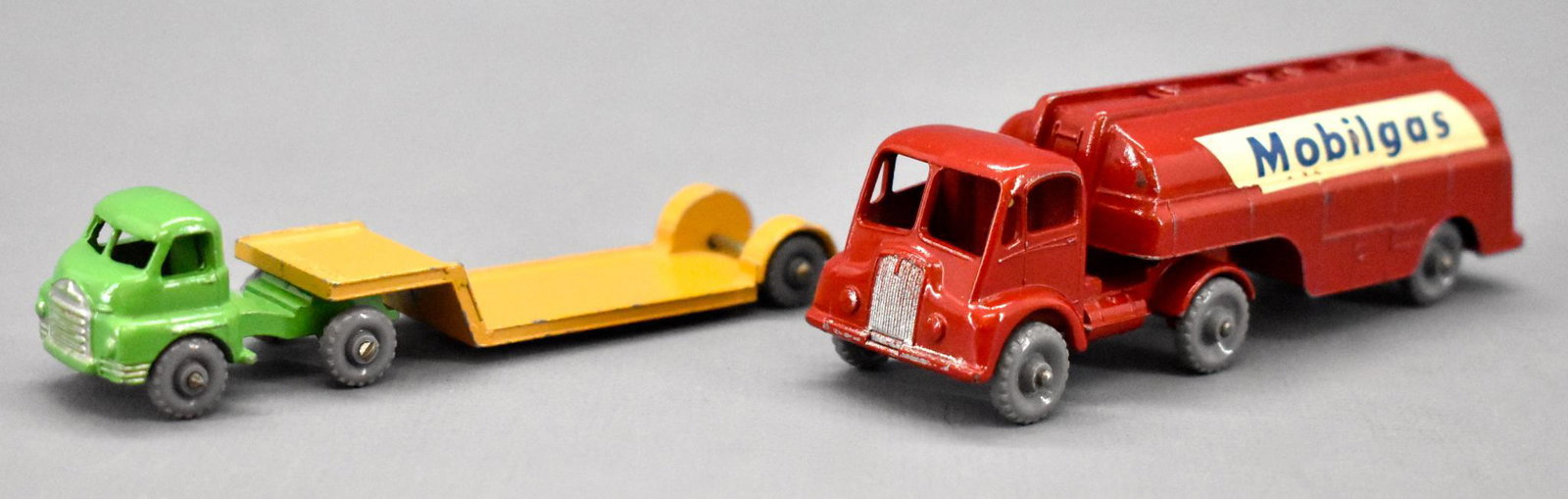 Pair of vintage Matchbox die cast semi tractor trailers: Pair of vintage Matchbox die cast semi tractor trailers with gray plastic wheels to include 27 Bedford Lowloader and Major Pack 8 Thornycroft 2400 gallon Mobilgas trailer tanker. Both are very good to