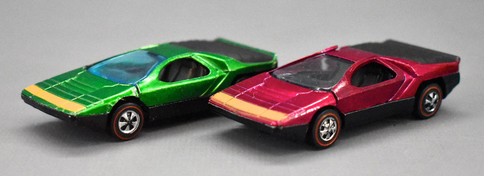 Pair of Redline Hot Wheels Carabo: Pair of Redline Hot Wheels Carabo to include a US in magenta and a HK in green, both have some wear but display nicely as seen in the photos.