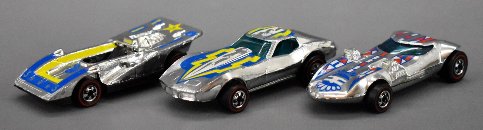 Three chrome Redline Hot Wheels Flying Colors HK: Three chrome Redline Hot Wheels Flying Colors HK castings with tampos to include Corvette Stingray, Twinmill and Steam Roller, all show some play wear but are in nice shape as seen in the photos.