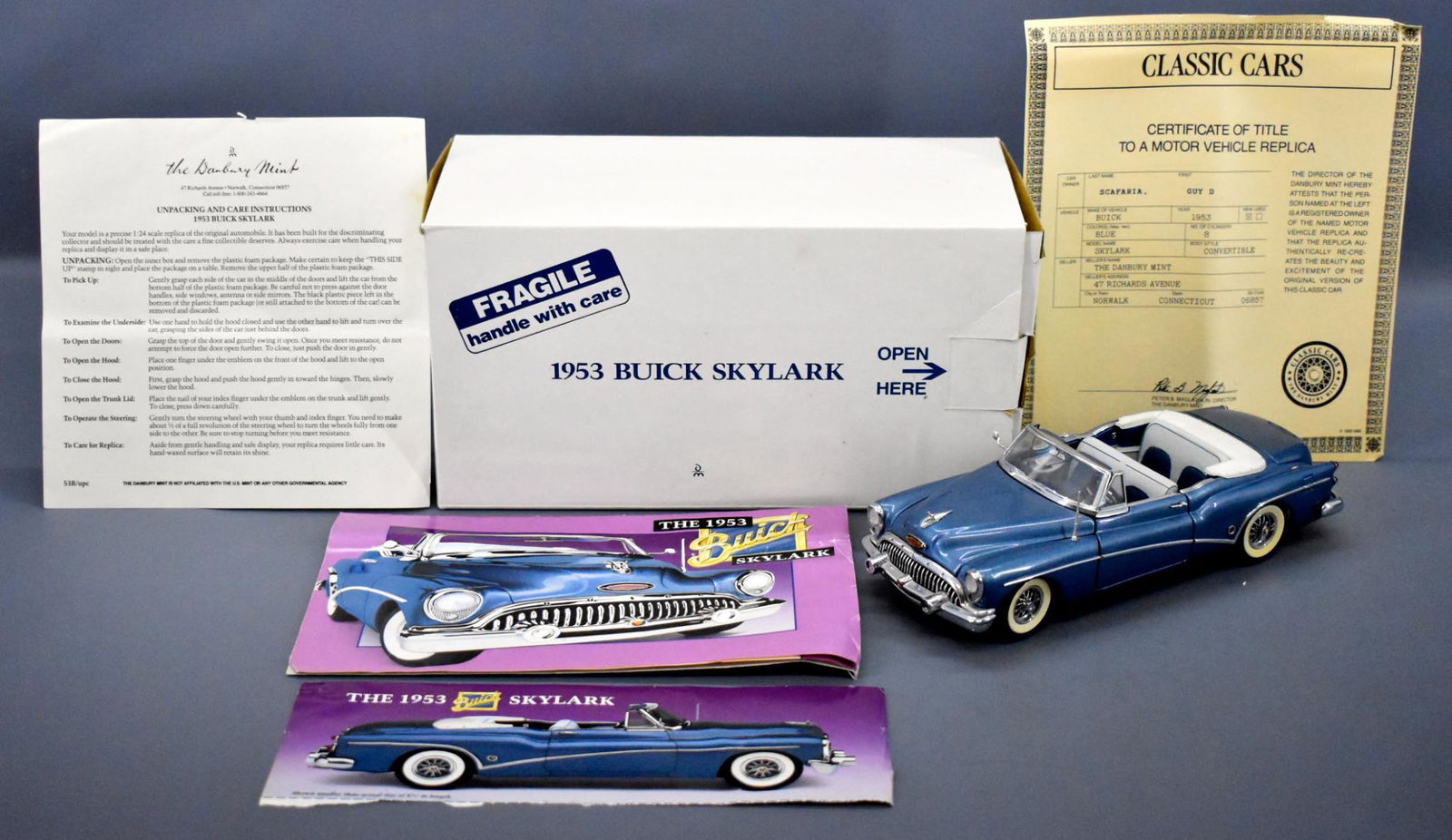 Danbury Mint 1953 Buick Skylark convertible die cast in: Danbury Mint 1953 Buick Skylark convertible die cast in original box, like new but has a tiny amount of dust on the interior with original paperwork and a near mint original box as seen in the photos.