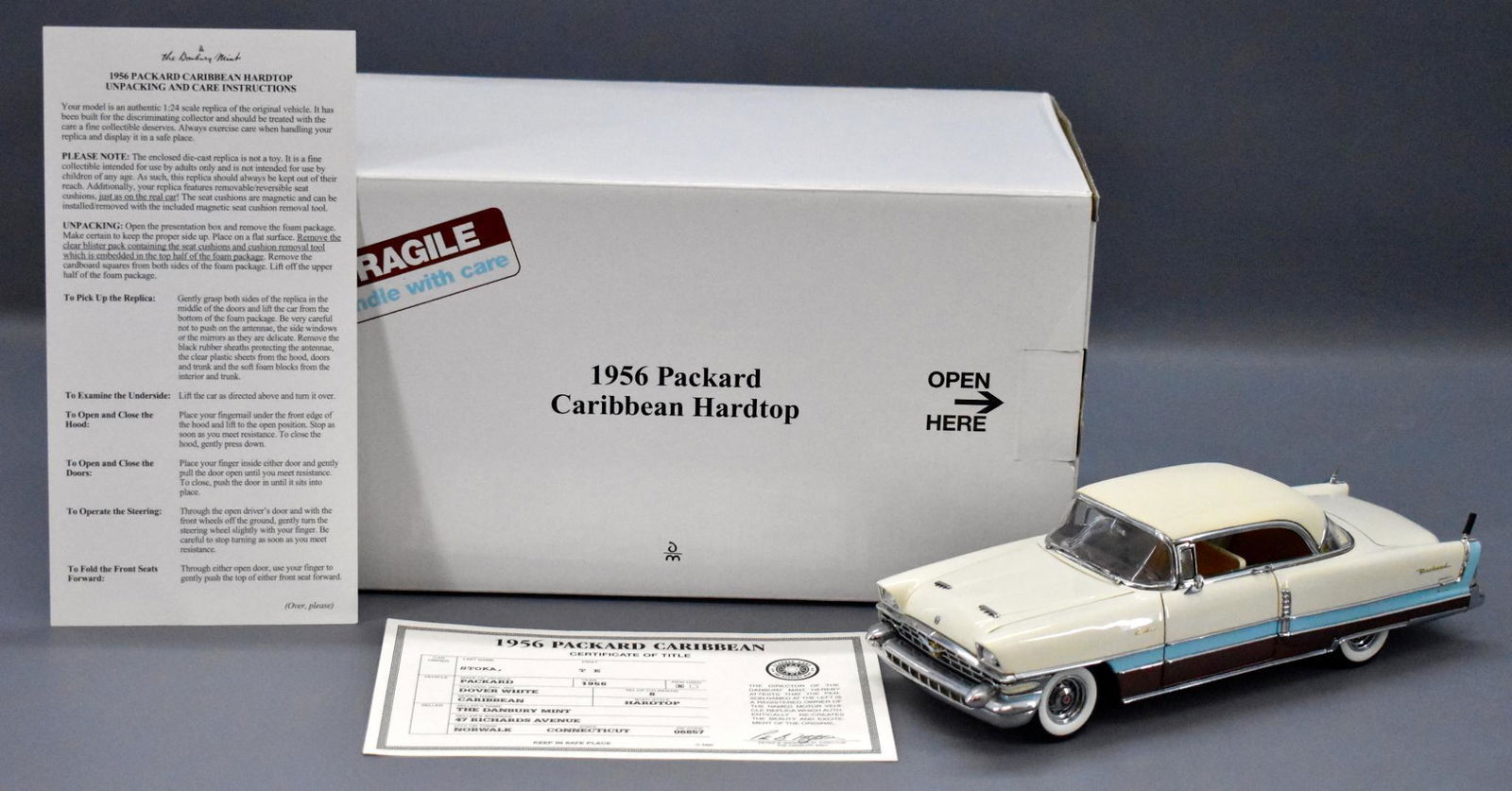 Danbury Mint 1956 Packard Caribbean hardtop die cast in: Danbury Mint 1956 Packard Caribbean hardtop die cast in original box, mint with original paperwork in a very good original box as seen in the photos.
