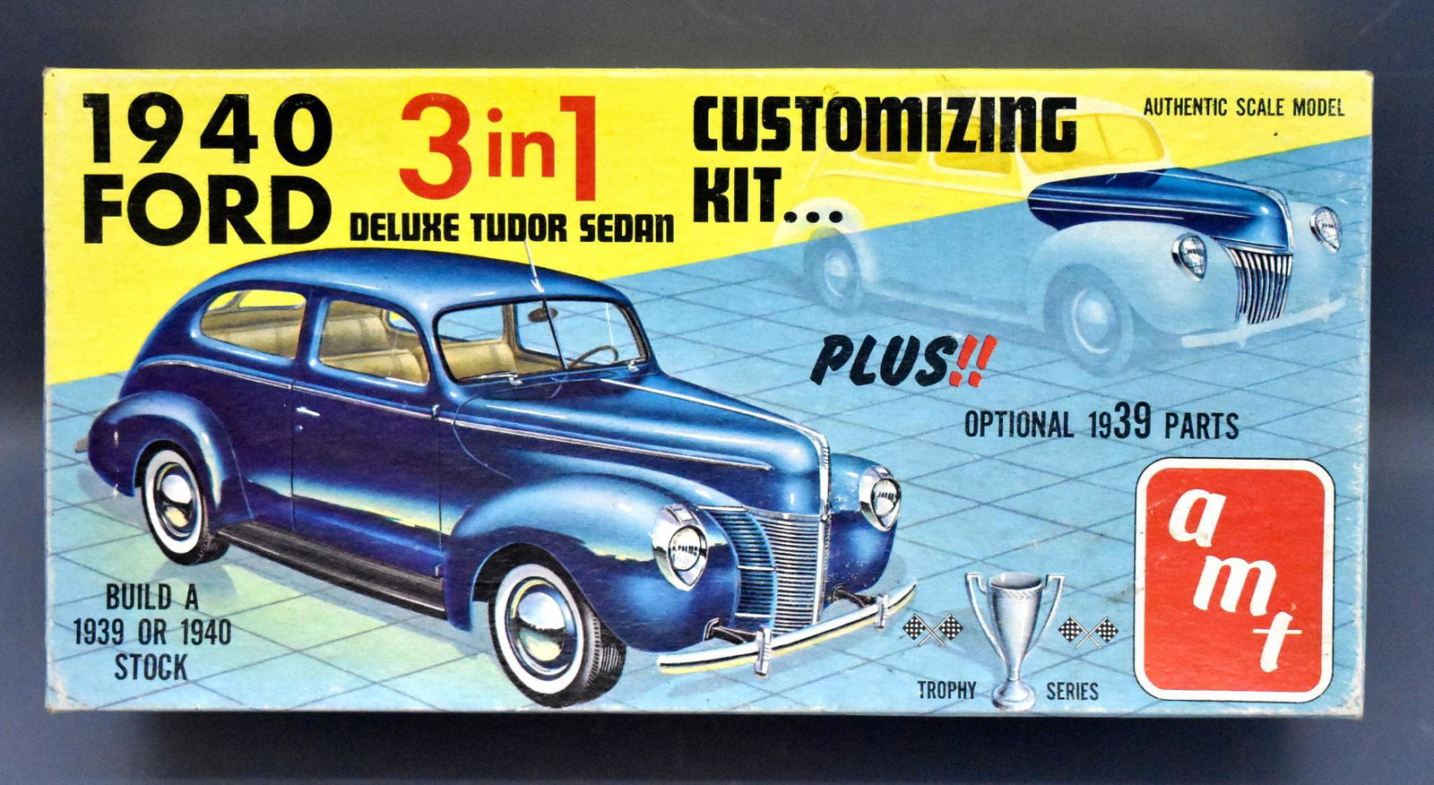Unbuilt AMT 1940 Ford deluxe tudor sedan 1/25 scale: Unbuilt AMT 1940 Ford deluxe tudor sedan 1/25 scale model kit in original box, stock number 240. The axles are attached to tires and some parts are loose from the sprues but no work appears to have be