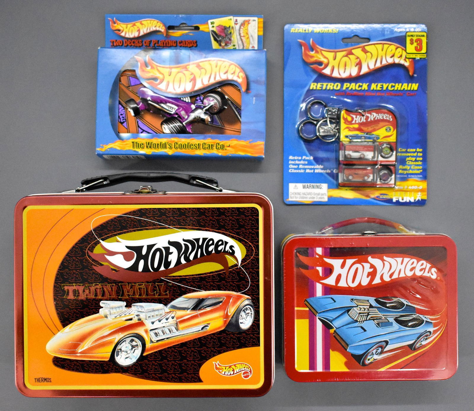 Group of modern Hot Wheels collectibles with lunch: Group of modern Hot Wheels collectibles with miniature and regular sized lunch boxes, keychains and playing cards. The large lunch box is no longer factory sealed whereas everything else is.