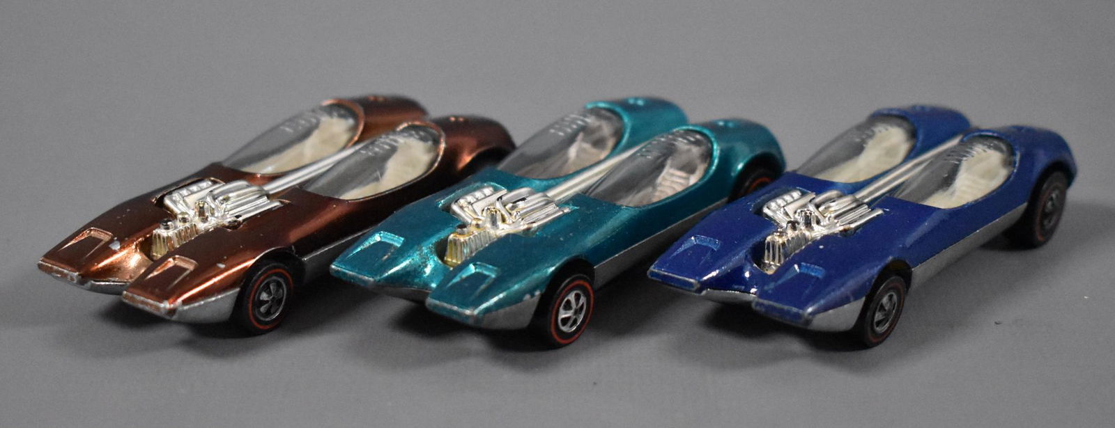 Three Original Redline Hot Wheels Splittin' Image: Three Original Redline Hot Wheels Splittin' Image to include enamel blue, brown and aqua, clean with play wear as seen in the photos.