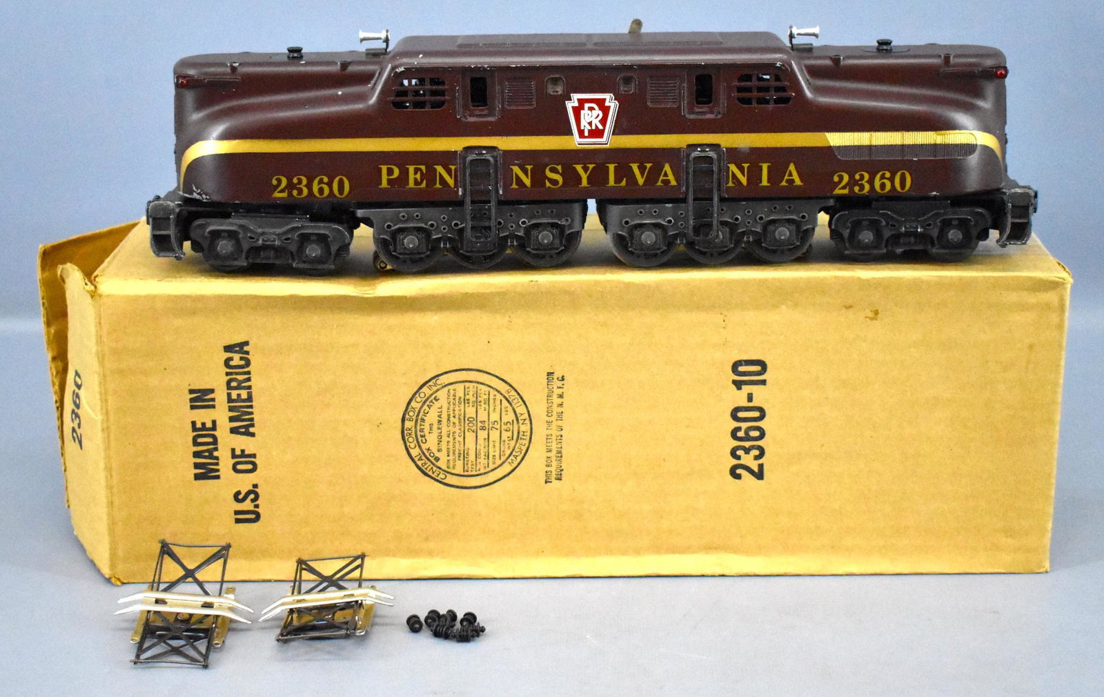 Lionel postwar O 2360 Pennsylvania solid stripe GG-1: Lionel postwar O 2360 Pennsylvania solid stripe GG-1, has a replacement frame but everything else appears to be original. There is some paint missing on the bottom of one side that caused a portion of