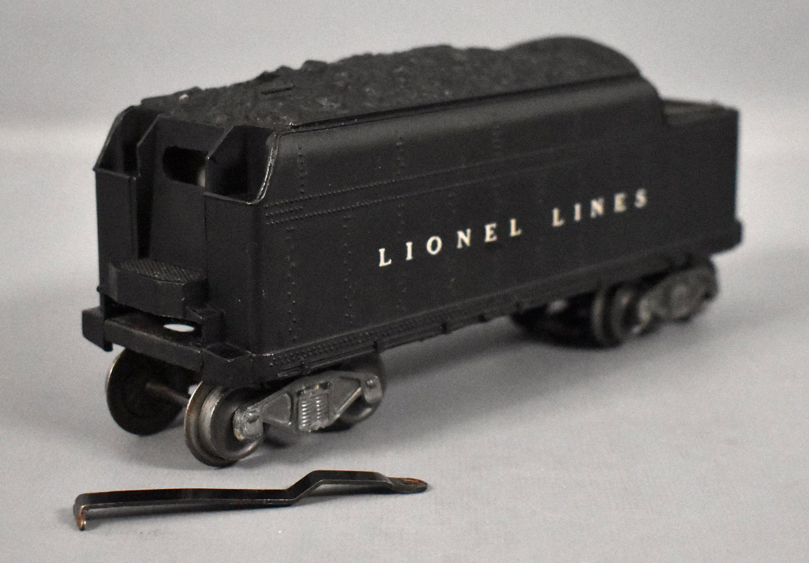 Lionel postwar O 2466W tender with flying shoe trucks: Lionel postwar O 1945 ONLY 2466W tender with flying shoe trucks from the 463W Christmas set, C6-7 with some paint missing on both sides.