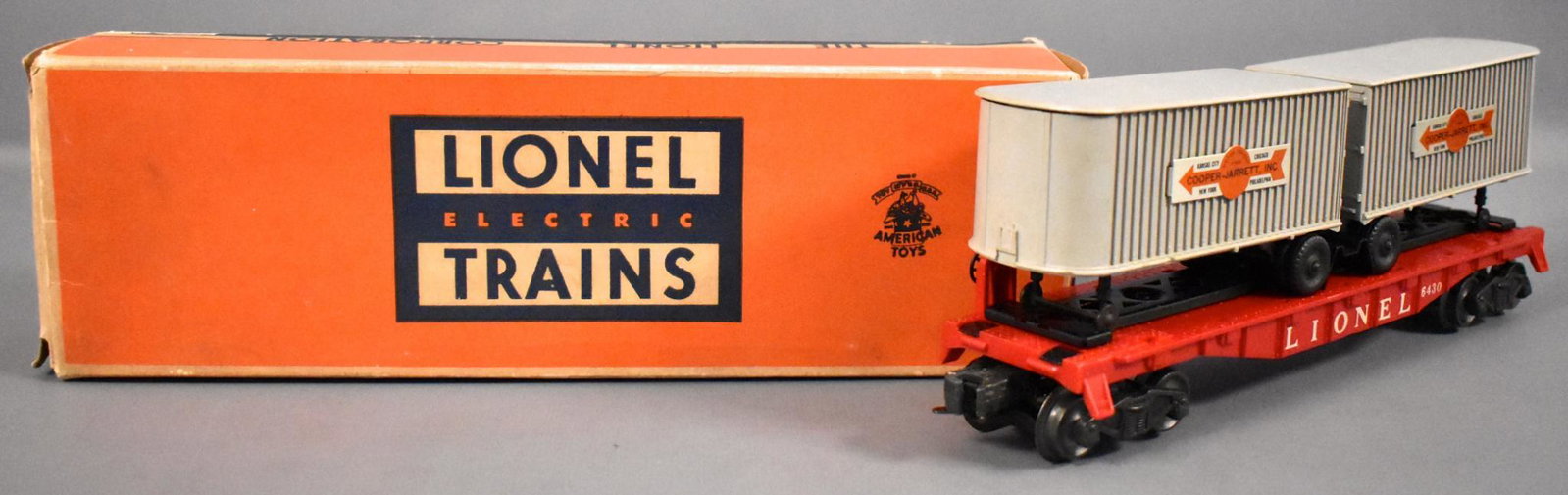 Lionel postwar O 6430 flat car with Cooper Jarrett: Lionel postwar O 6430 flat car with Cooper Jarrett trailers in original box, shows moderate run time and is C7 with a very good original box.