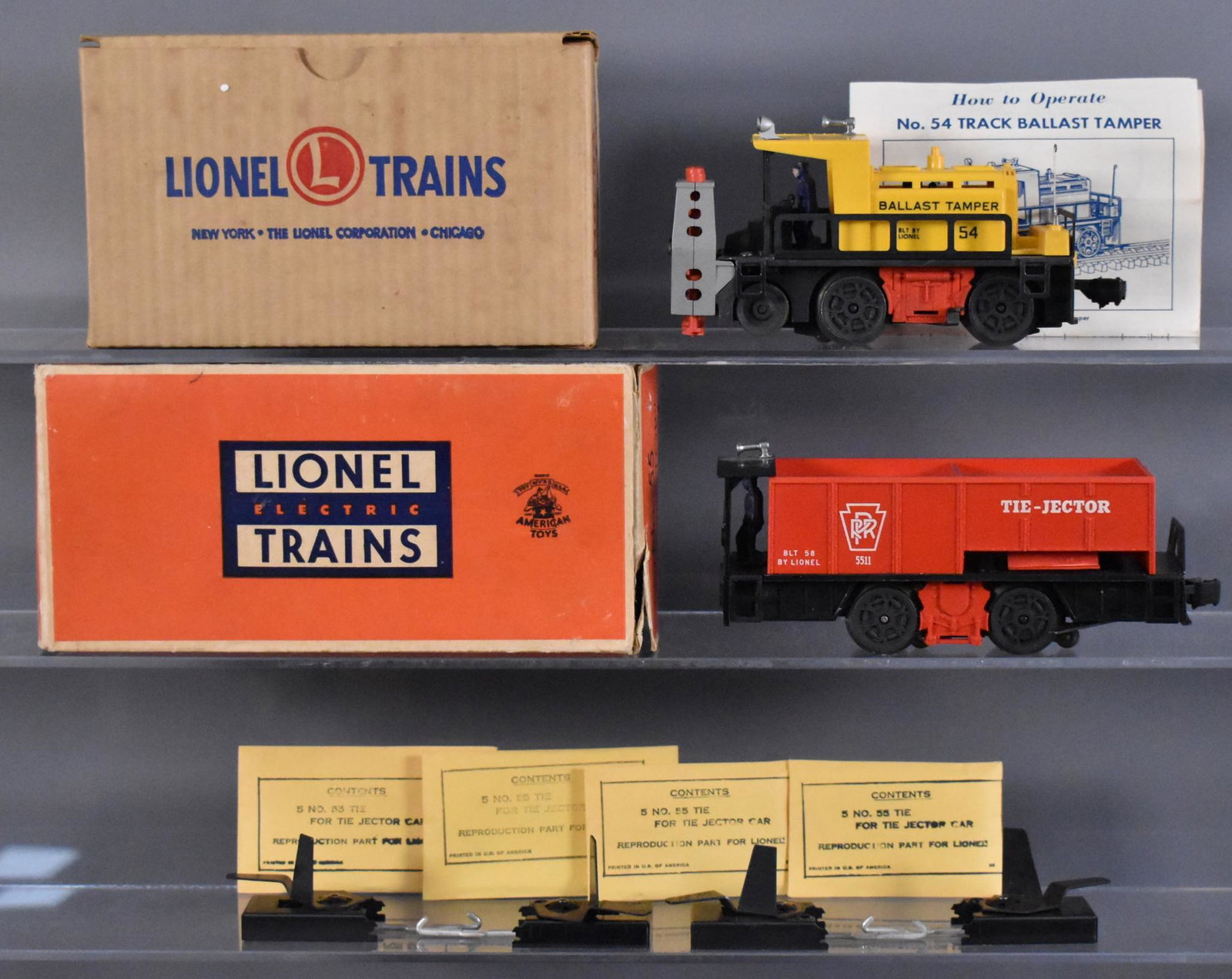 Lionel postwar O 54 55 motorized units in original: Lionel postwar O 54 track ballast tamper and 55 tie-jector car in original boxes, C7 with track trips and several wooden ties in reproduction packets and two very good to excellent original boxes as s