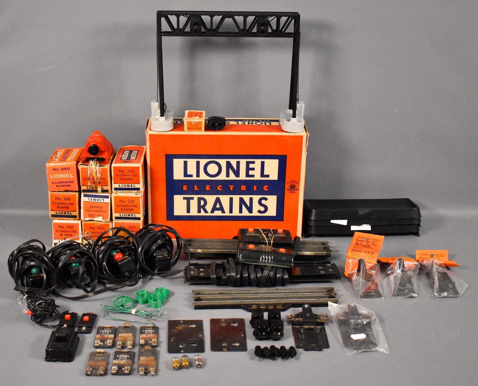 Large group of small Lionel postwar O accessories and: Large group of small Lionel postwar O accessories and parts to include 450 operating signal bridge, ten 260 illuminated bumpers, five 160 bins, several 022 switch controllers two UCS sets and more as 