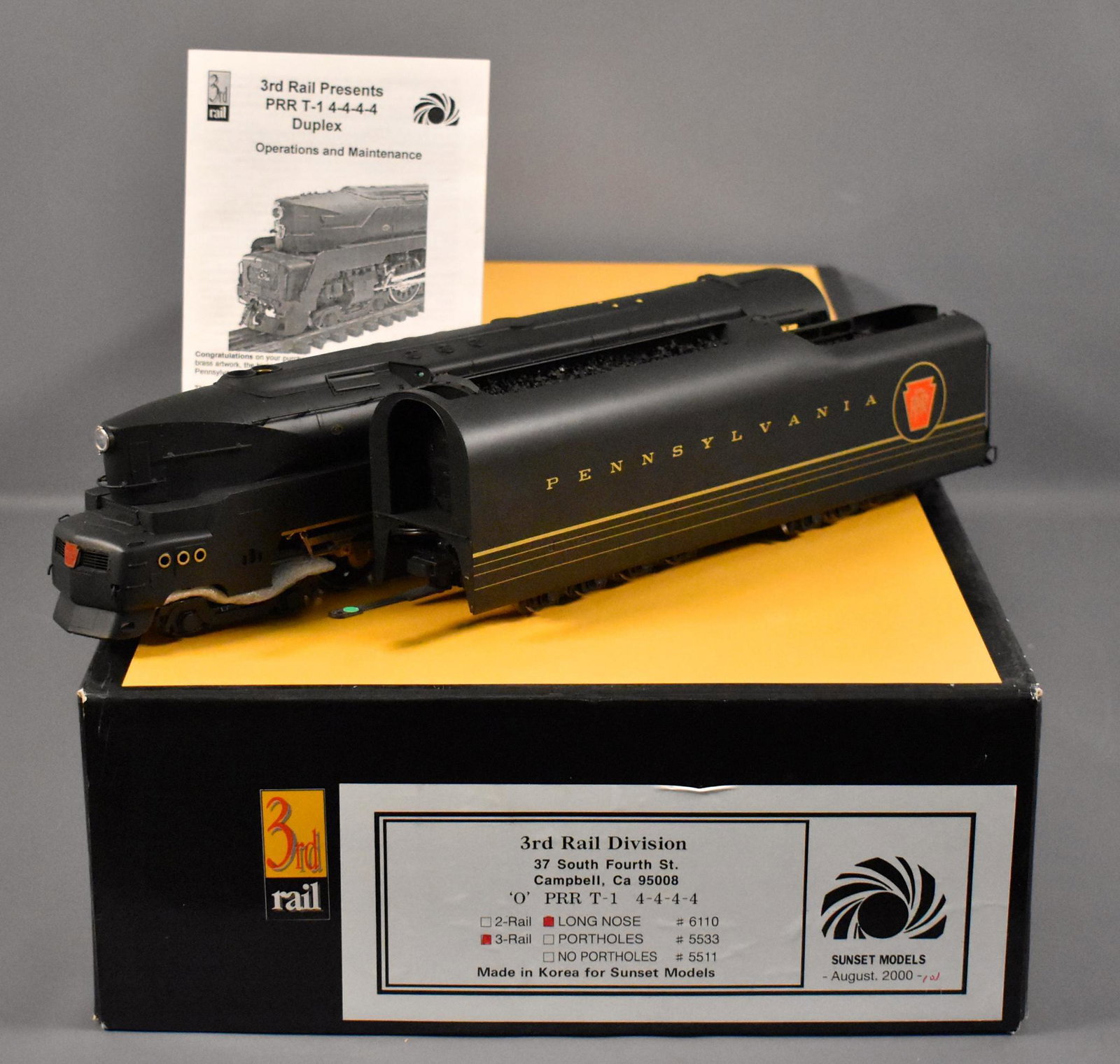 Sunset 3rd rail O scale 3 rail brass Pennsylvania T-1: Sunset 3rd rail O scale 3 rail brass Pennsylvania long nose T-1 4-4-4-4 steam locomotive, cab #6110 in original box, shows light run time and is C8. The tow bar on the tender has come loose but can be